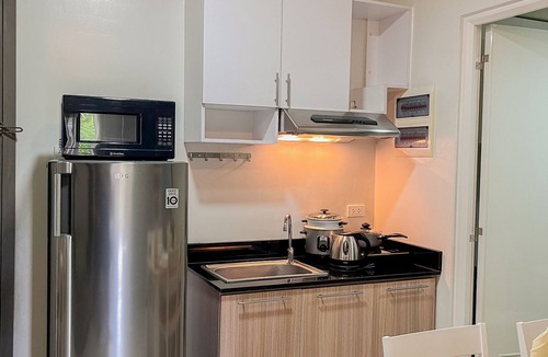 Puerto Princesa City Centre Apartment | Emerald 2 bedroom apartment with a pool, gym, and a balcony with a view