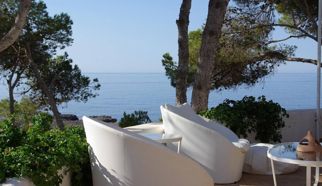 A large villa with garden and terraces at the water's edge