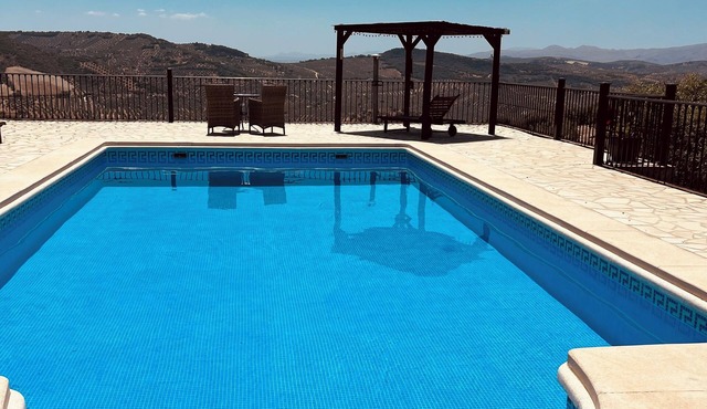 Private, hillside cottage with spectacular views, air con & secluded pool.